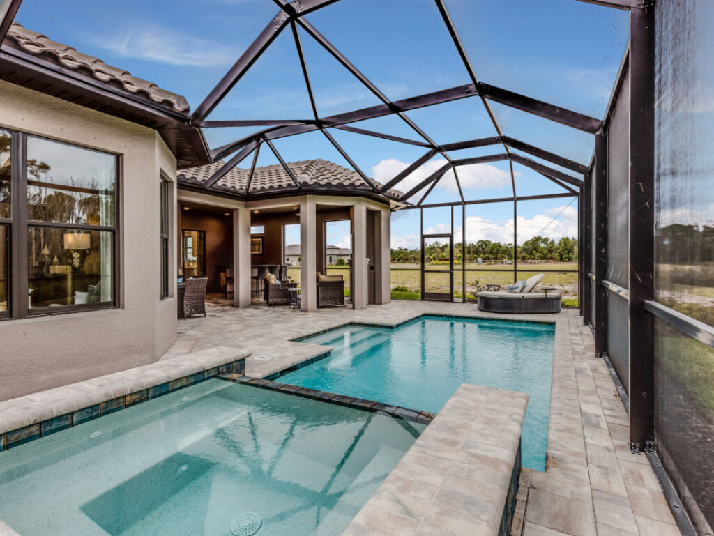 Screened-in pool area of a home, designed to protect against water damage and outdoor elements.
